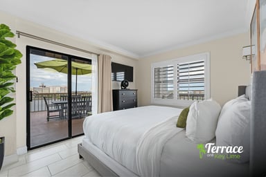 Bright king bedroom with private balcony and scenic water views